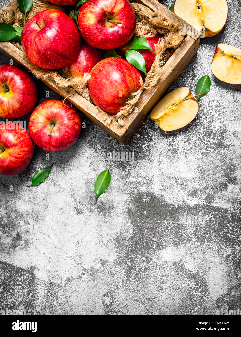 Red apples in an old box. On rustic background Stock Photo - Alamy