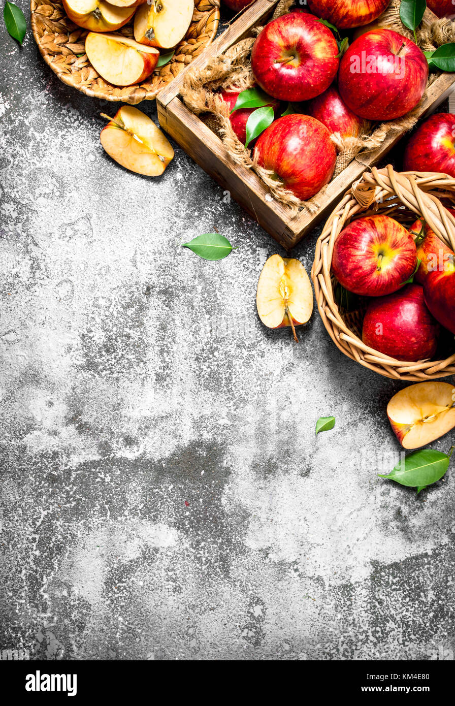 Red apples in the box and baskets. On rustic background Stock Photo - Alamy