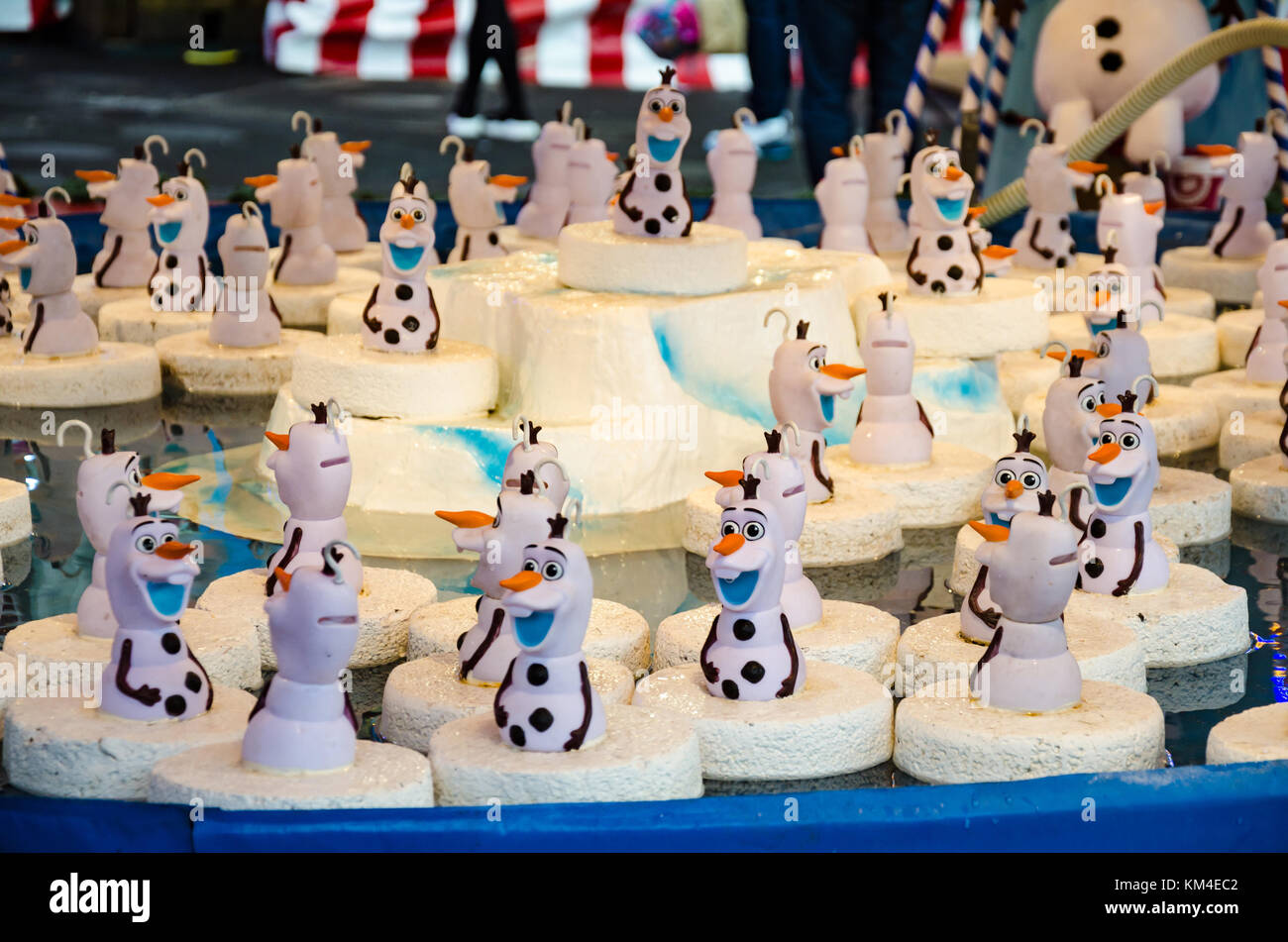 A 'hook-a-duck' style game at a fairground stall featuring the snowman character Olaf from the Disney Film 'Frozen'. Stock Photo