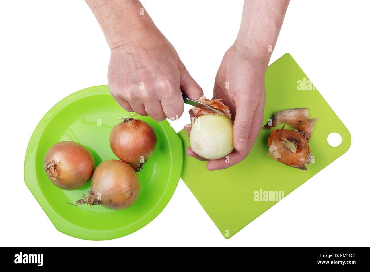 Clean Onions Cook in the kitchen with a knife cleans the onions from the husks Stock ...