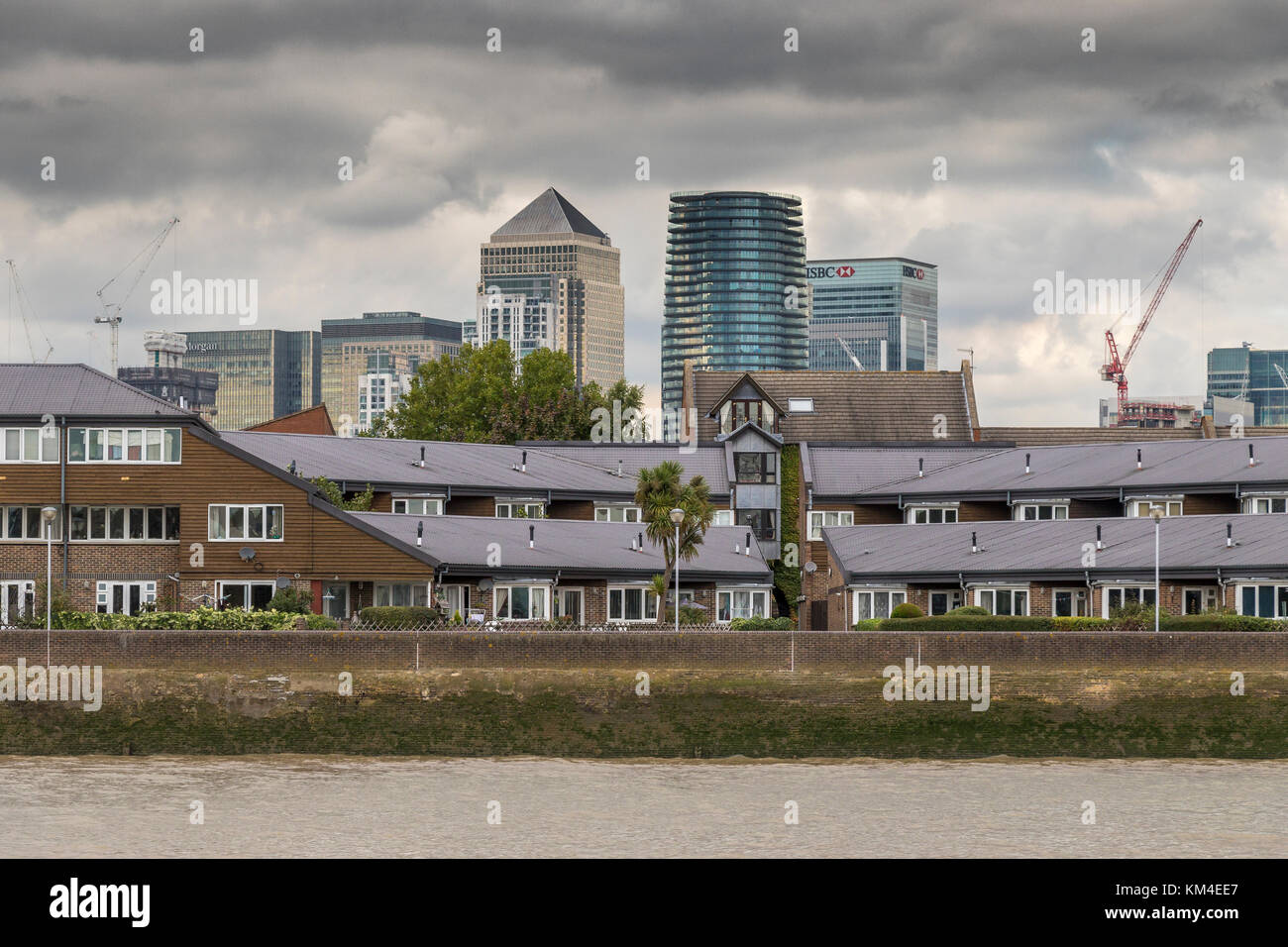 The Towers Of Canary Wharf oversee River Side Apartments, Flats and houses along the banks of