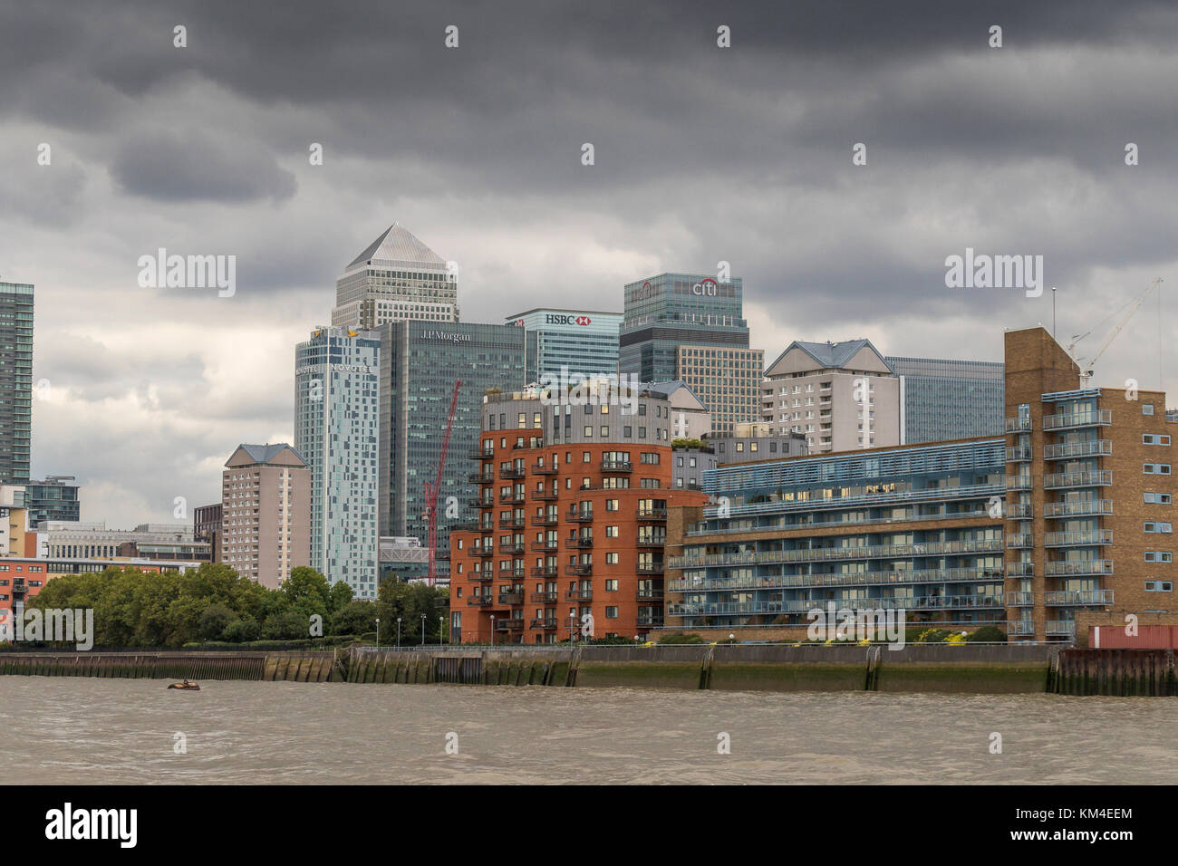 The Towers Of Canary Wharf oversee River Side Apartments, Flats and houses along the banks of The River Thames , London , United Kingdom Stock Photo