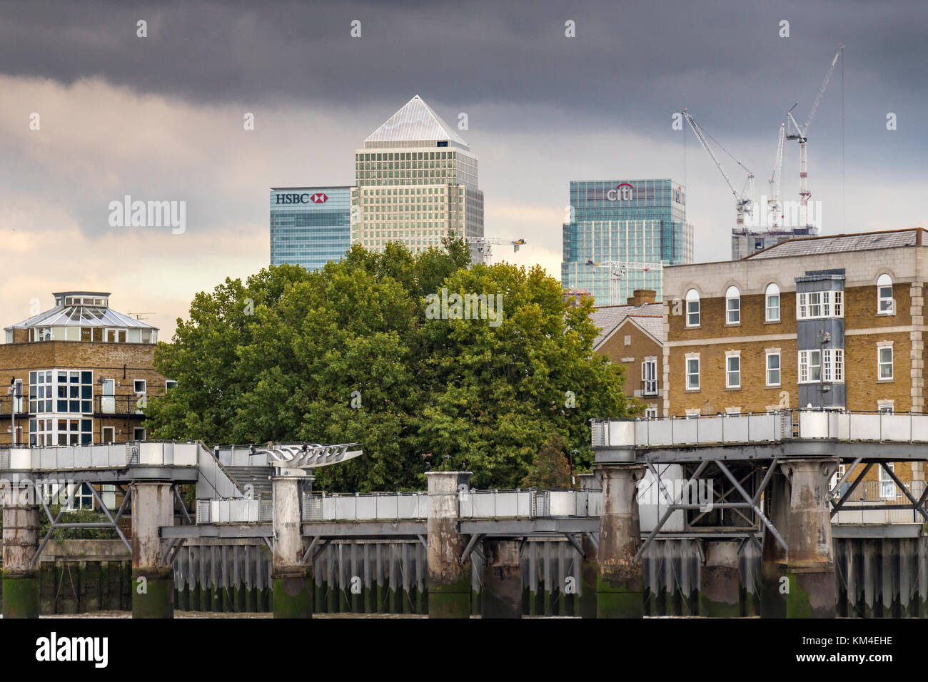 The Towers Of Canary Wharf oversee River Side Apartments, Flats and houses along the banks of