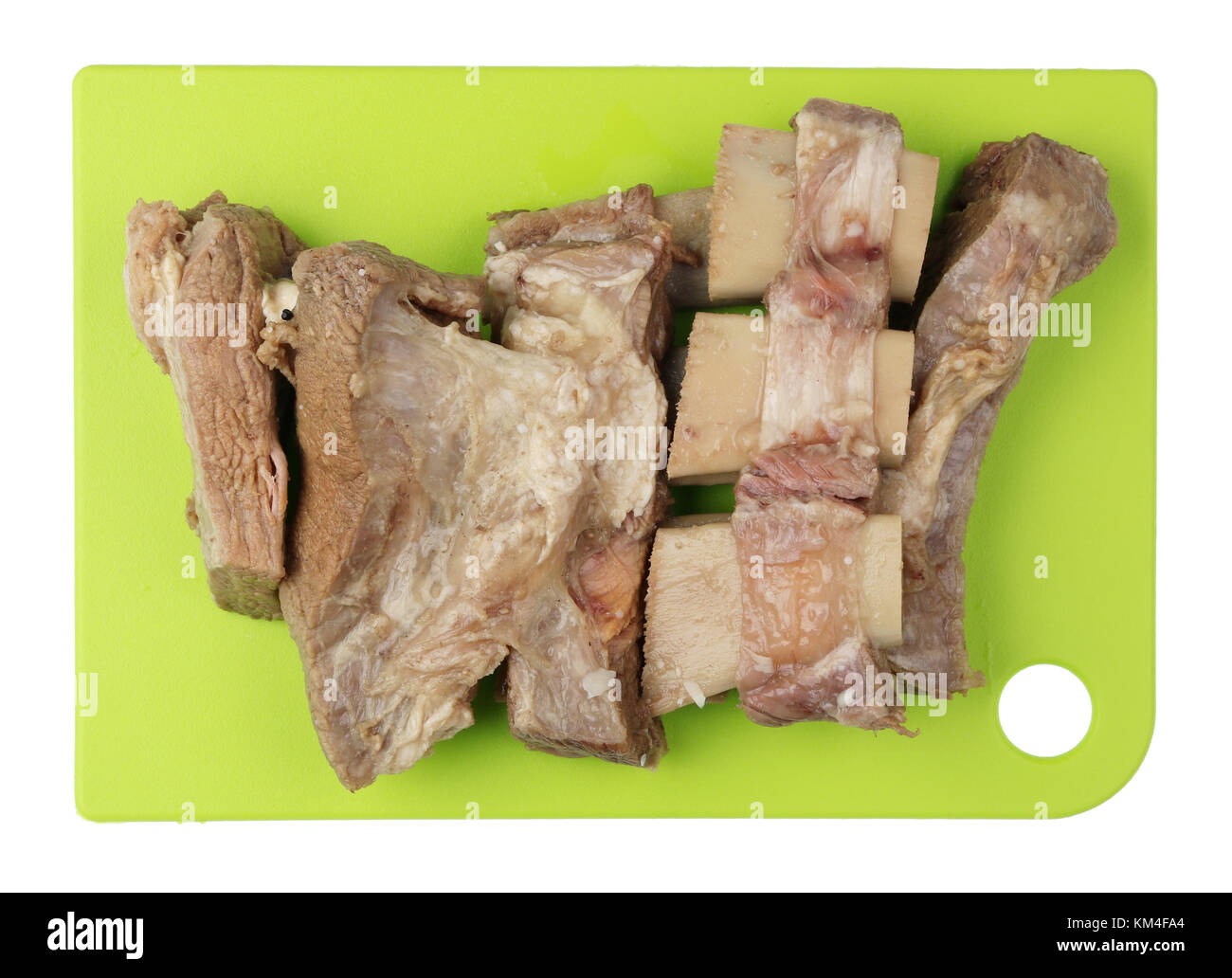 Boiled beef ribs with meat on a green kitchen cutting board. It is  a basis of dietary food for hemoglobin restoration. Isolated on white concept Stock Photo