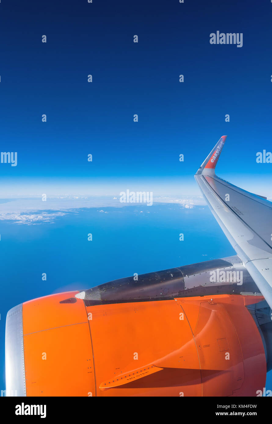 Lanzarote, Spain - December 20, 2016: easyJet logo on airplane's wing in mid-air over Atlantic Ocean. easyJet is a British low-cost airline Stock Photo