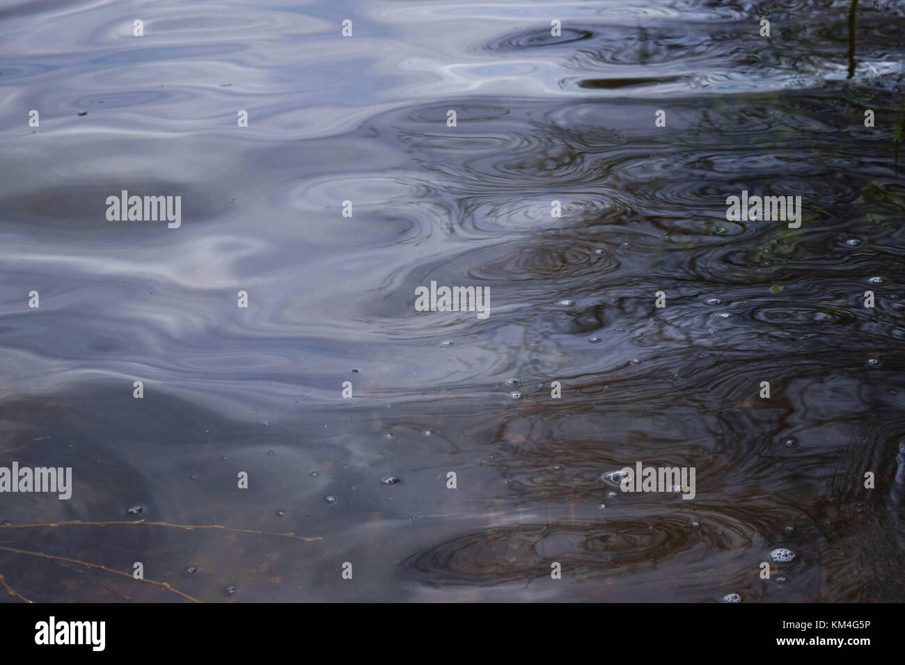 Reflection and ripples caught on the surface of a lake Stock Photo - Alamy