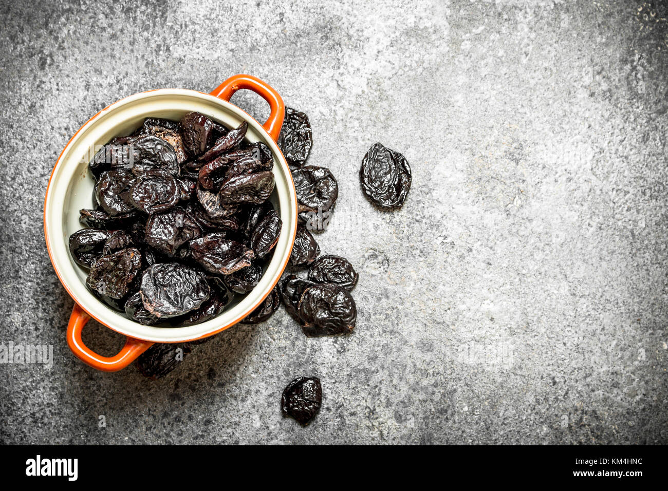 Prunes in a bowl. On rustic background . Stock Photo