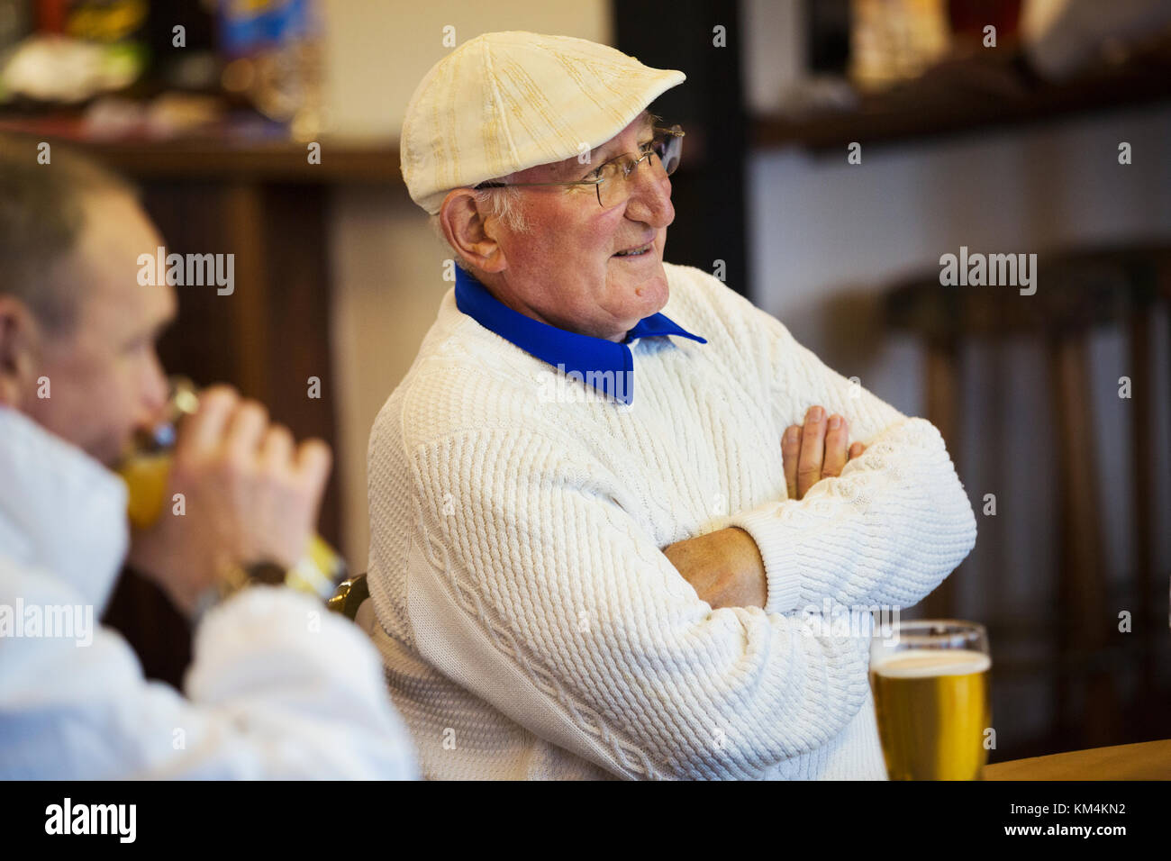 Two men at a lawn bowls club seated with pints of beer. Post match analysis. Stock Photo