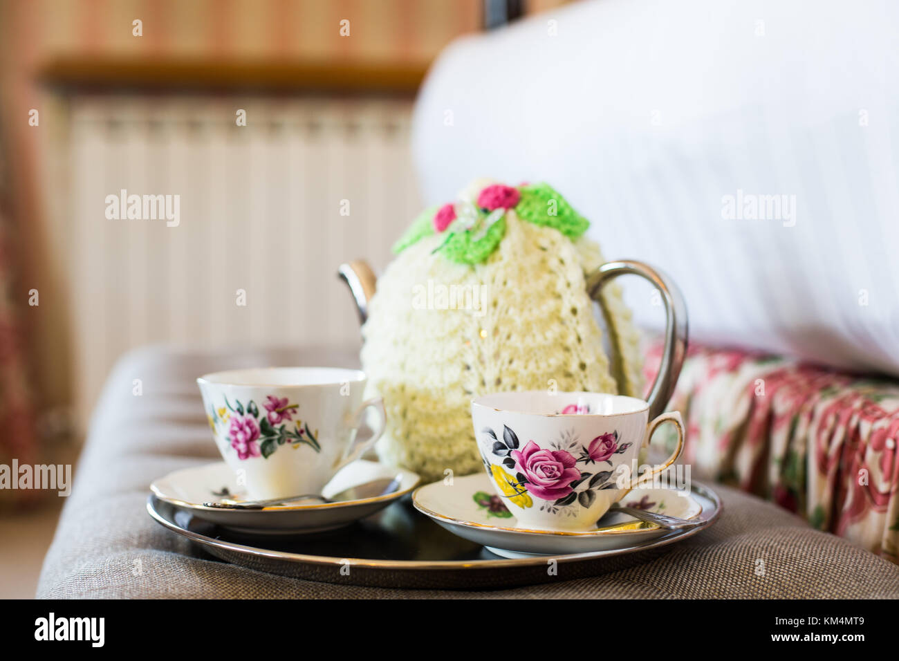 English tea pot with cosy and tea cups in country hotel Stock Photo