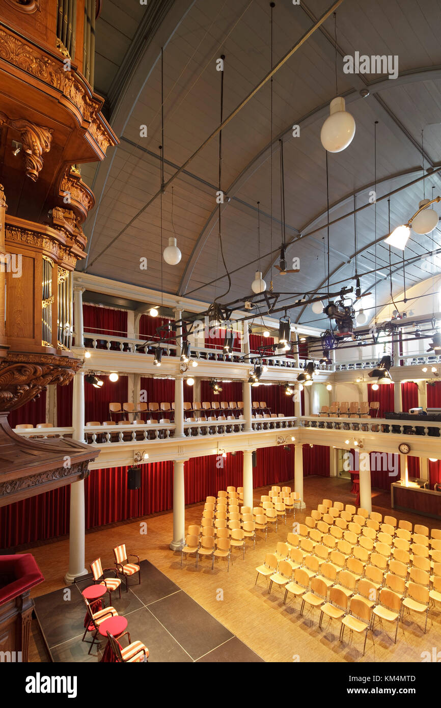 View from balcony towards rear of auditorium. De Rode Hoed Cultural Centre, Amsterdam, Netherlands. Architect: Unknown, 1630. Stock Photo