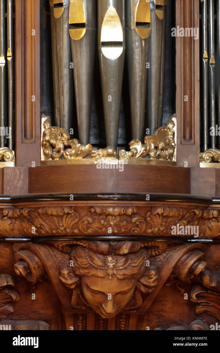 Detail of wood carving below organ with pipes above. De Rode Hoed Cultural Centre, Amsterdam, Netherlands. Architect: Unknown, 1630. Stock Photo