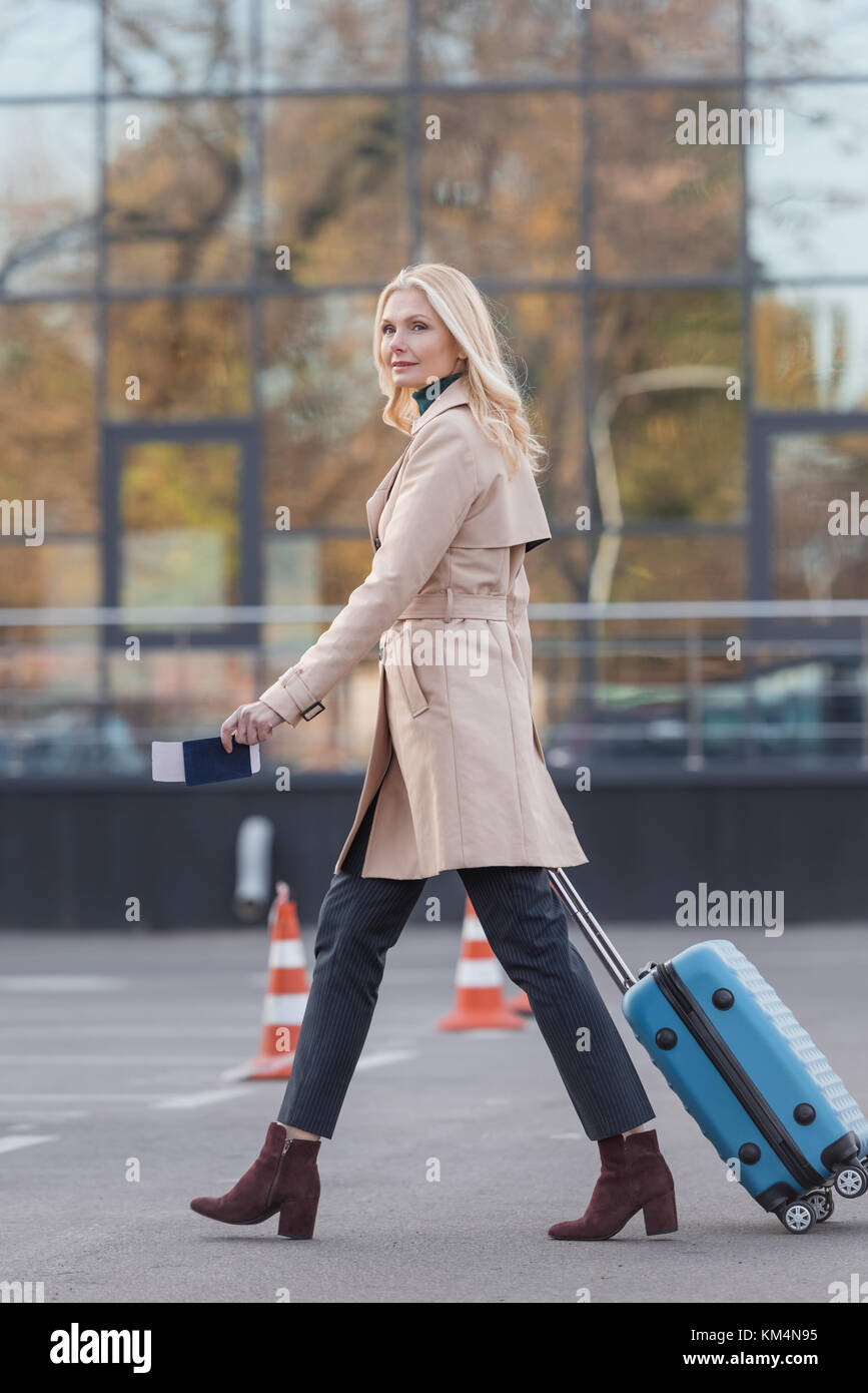 woman with suitcase and flight ticket Stock Photo - Alamy