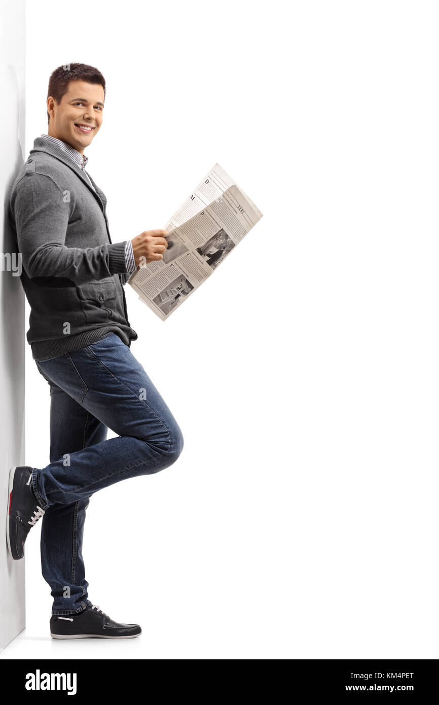 Full Length Portrait Of A Guy With A Newspaper Leaning Against A Wall Isolated On White Background Stock Photo Alamy Full Length Portrait Of A Guy With A Newspaper Leaning Against A Wall Isolated On White Background Stock Photo Alamy
