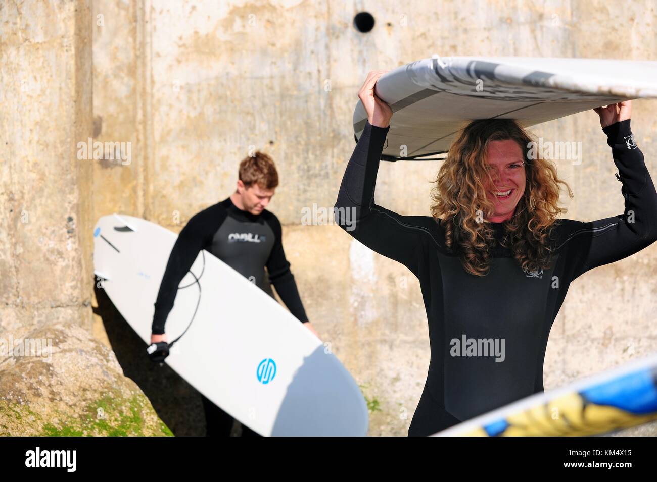 Military members from the Defense Language Institute Foreign Language Center try their hand at surfing along the beaches at the Presidio in Monterey, California. Stock Photo