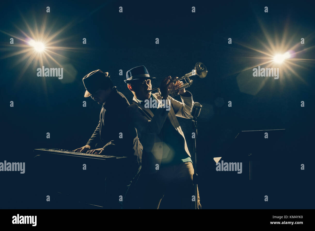 Musician Duo band playing a Trumpet and keyboard on black background