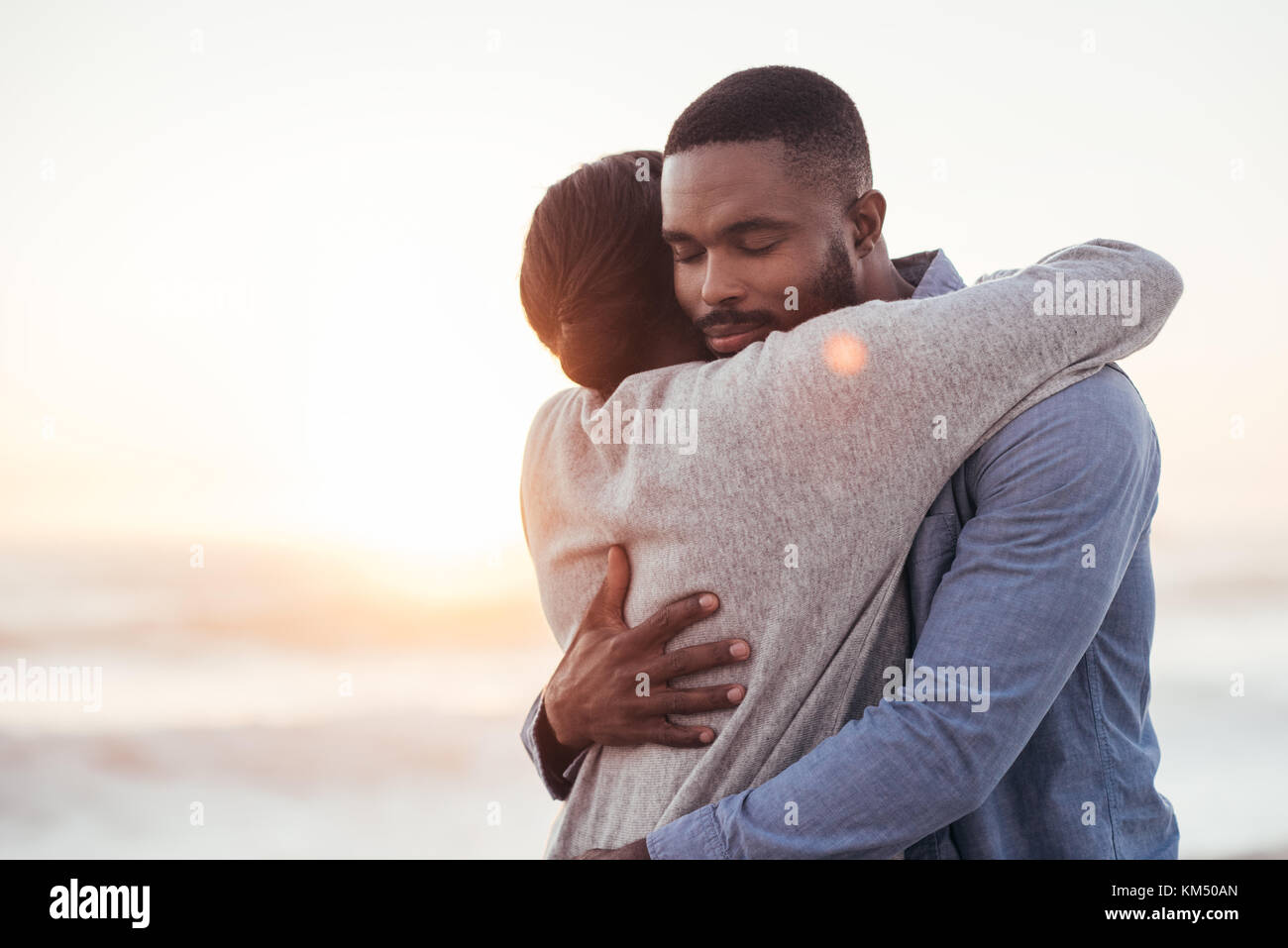 Content young African couple embracing each other at the beach Stock ...