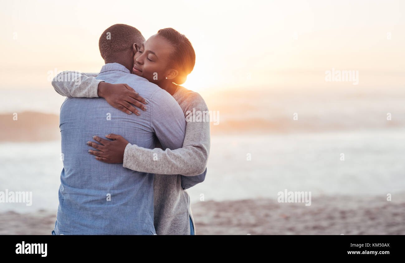 Content young African couple embracing each other at the beach Stock ...