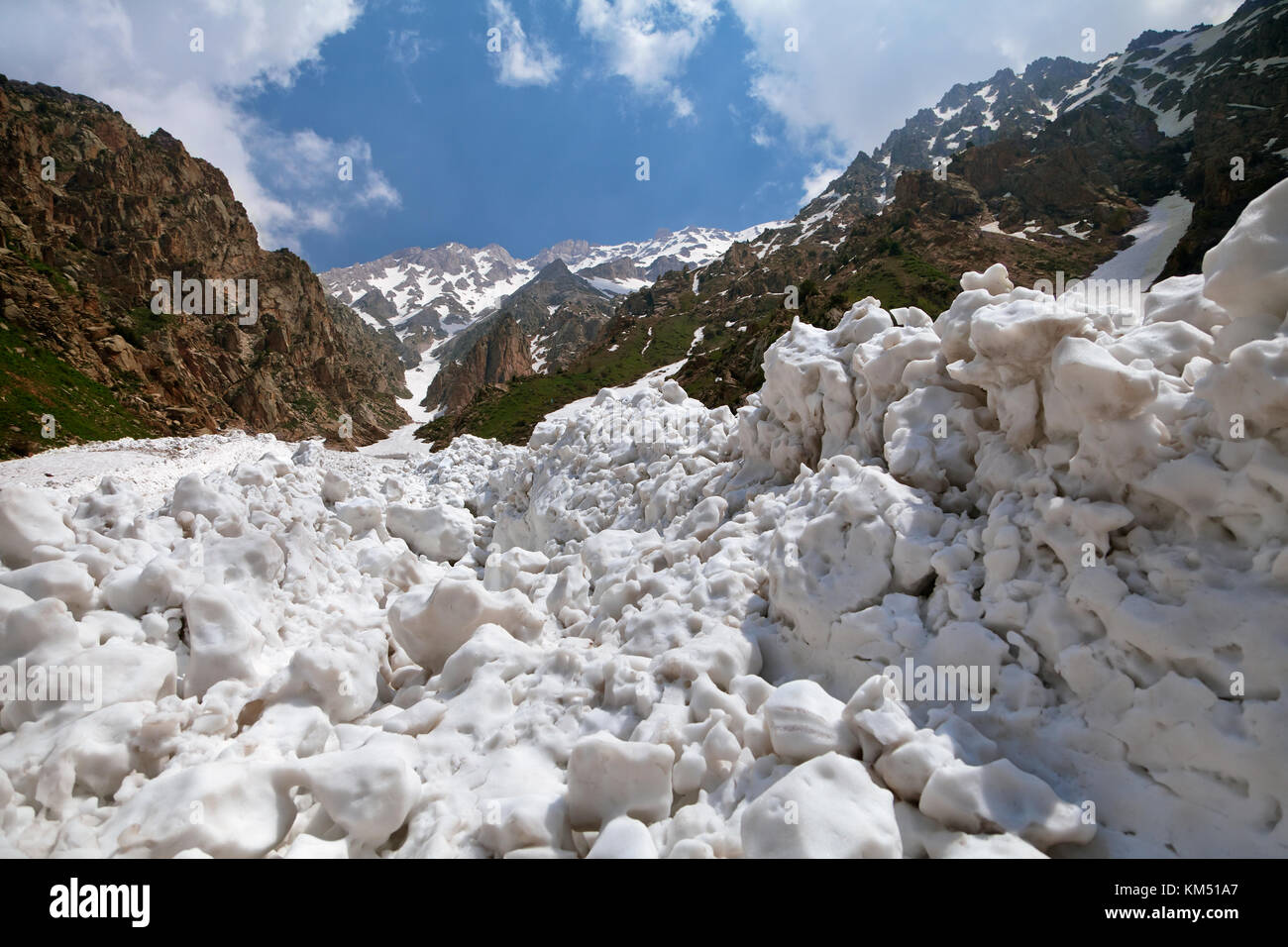 Snow after an avalanche in Chimgan mountains, Uzbekustan Stock Photo