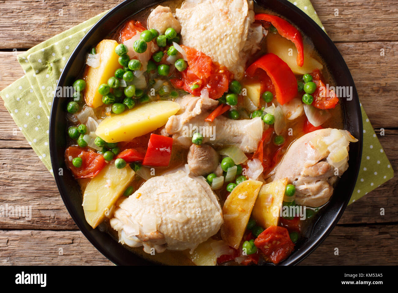 Filipino Afritada: slices of chicken with vegetables close-up in a bowl on the table. horizontal top view from above Stock Photo