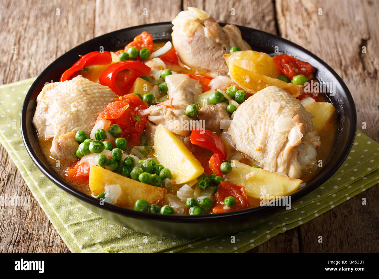 Chicken meat stewed with vegetables and spices close-up in a bowl on the table. horizontal Stock Photo
