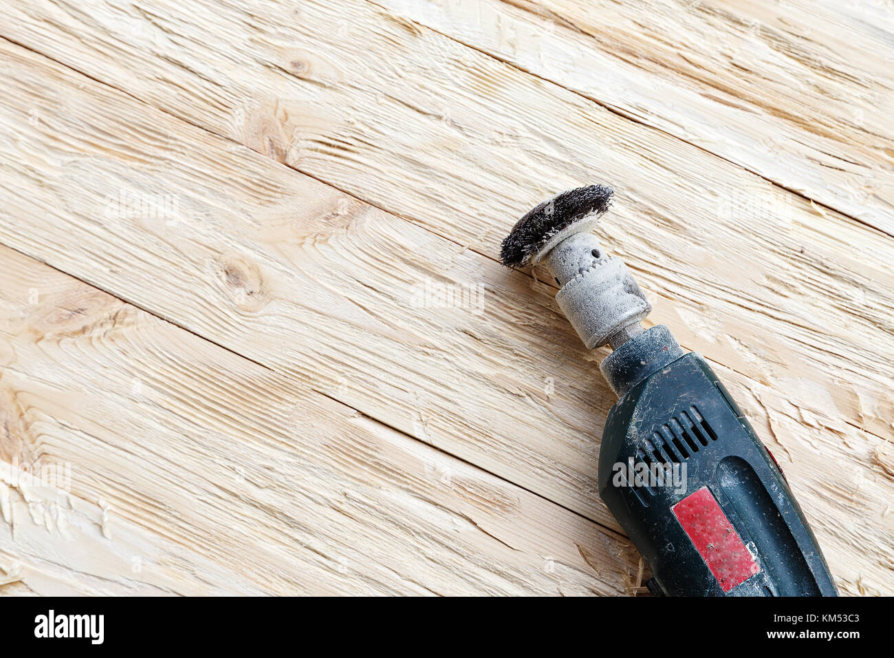 attachment on a drill, scrape, metal rotating brush. attachment is on a