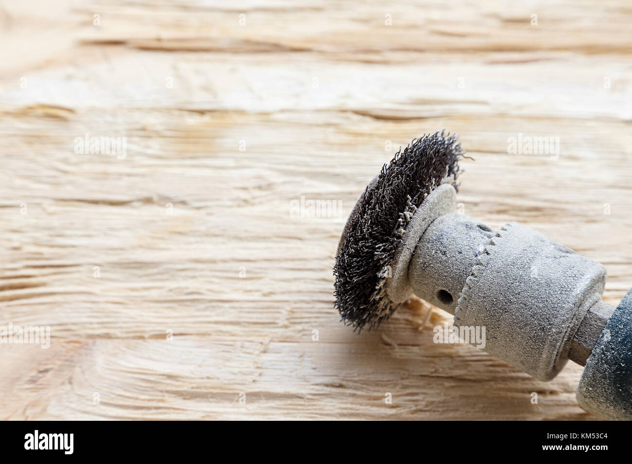 attachment on a drill, scrape, metal rotating brush. attachment is on a