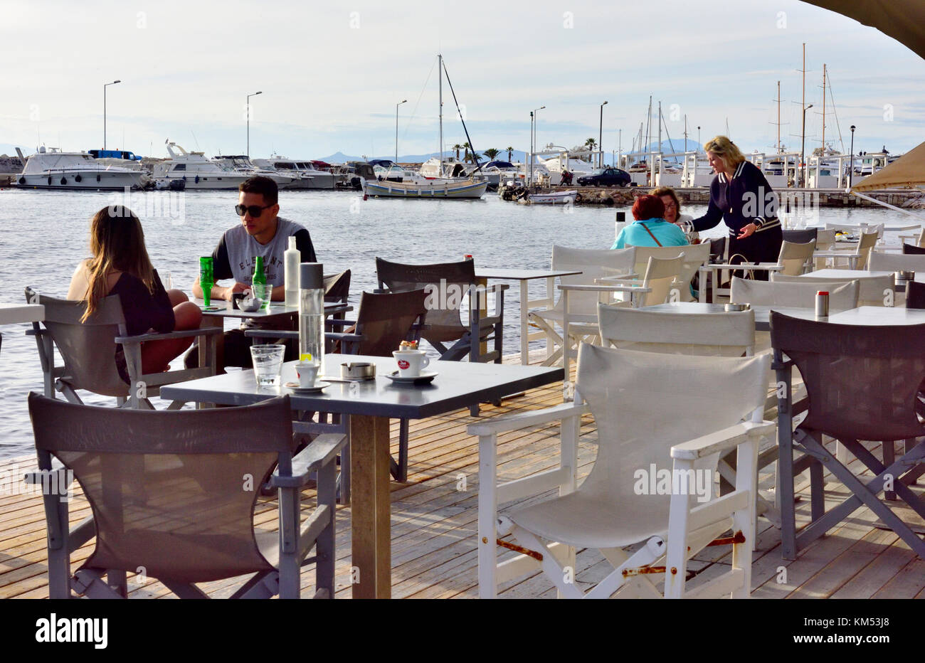 Restaurant overlooking seaside and harbour in Athens suburb of Glyfada, Saronic Golf, Greece Stock Photo