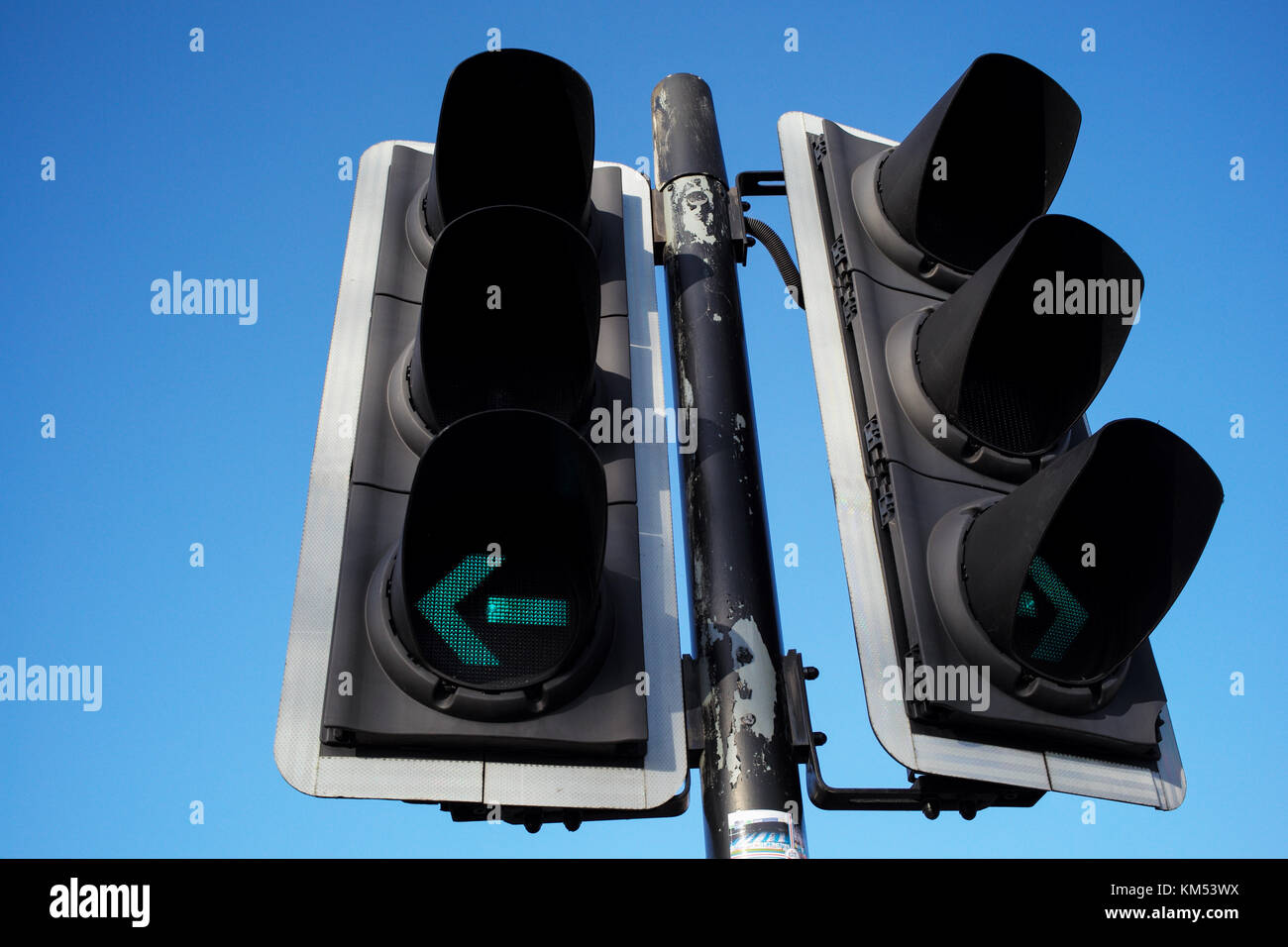 Traffic Light With Green Arrow Left And Right Turn Signal Against Blue 