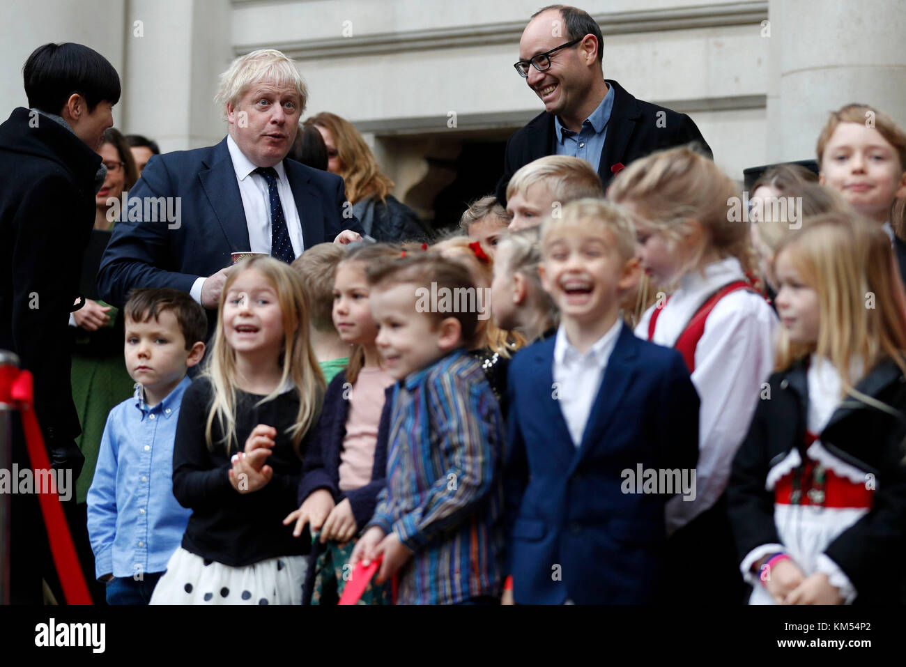 Foreign Secretary Boris Johnson reacts as he stands with with Norway's Foreign Secretary Ine Eriksen Soreide during the unveiling of a Christmas tree, gifted by Norway, outside The Foreign and Commonwealth Office (FCO) in London, after their bilateral talks. Stock Photo
