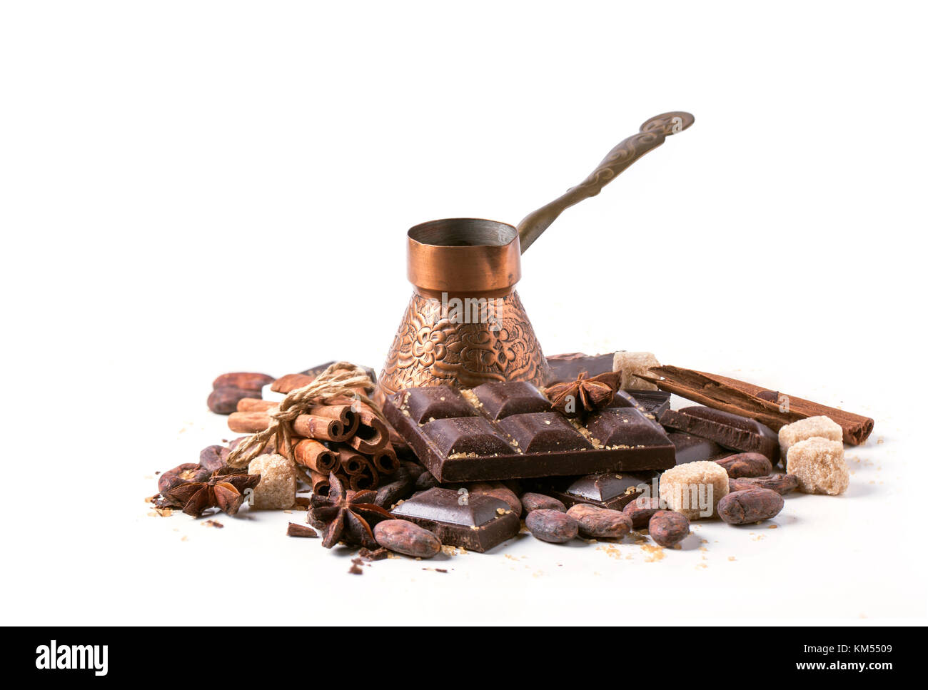 Vintage copper cezve with dark chocolate, cocoa beans, cinnamon and