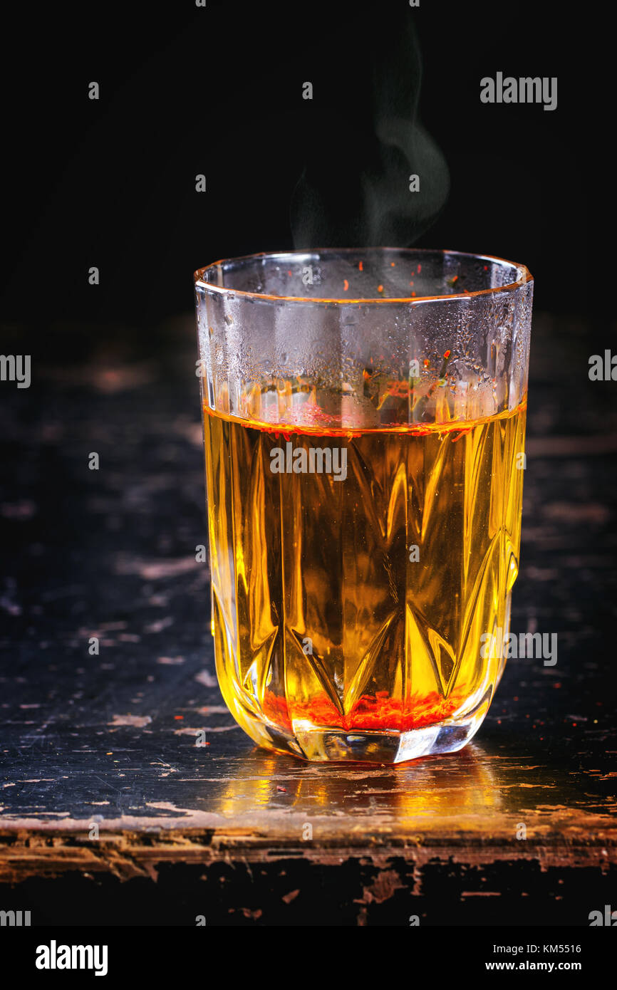 Vintage glass with saffron hot water. Stock Photo