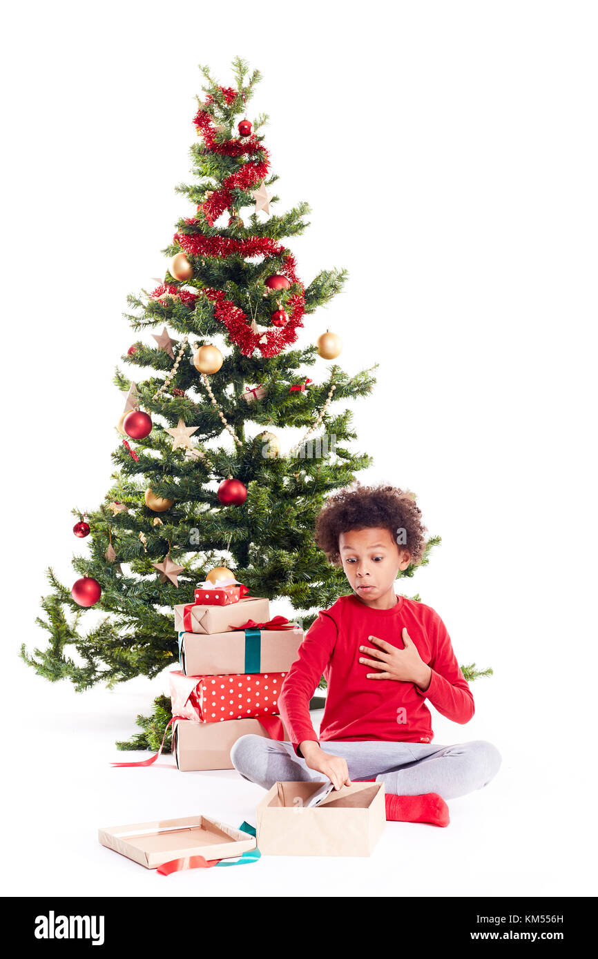 Boy unpacking Christmas gifts Stock Photo