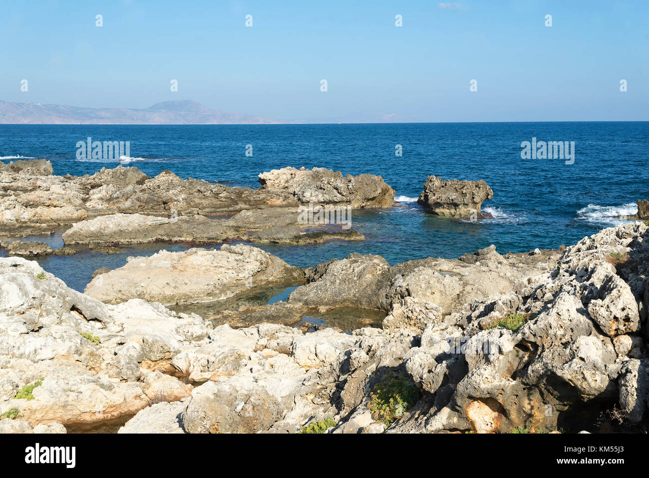 The waves breaking on a stony beach, forming a spray. Wave and splashes ...