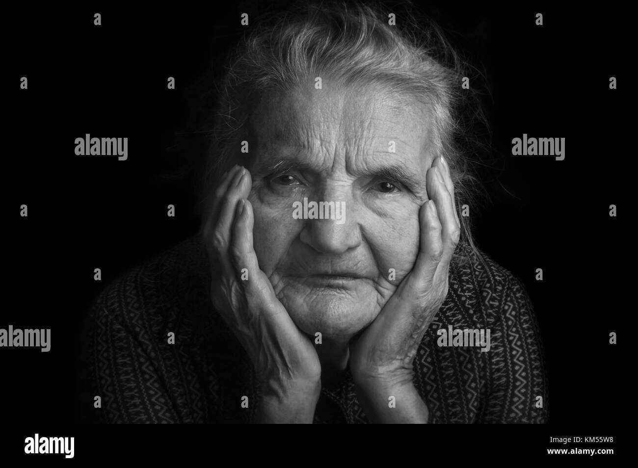 Portrait of a sad elderly woman. Dreaming the past. Selective focus. Stock Photo