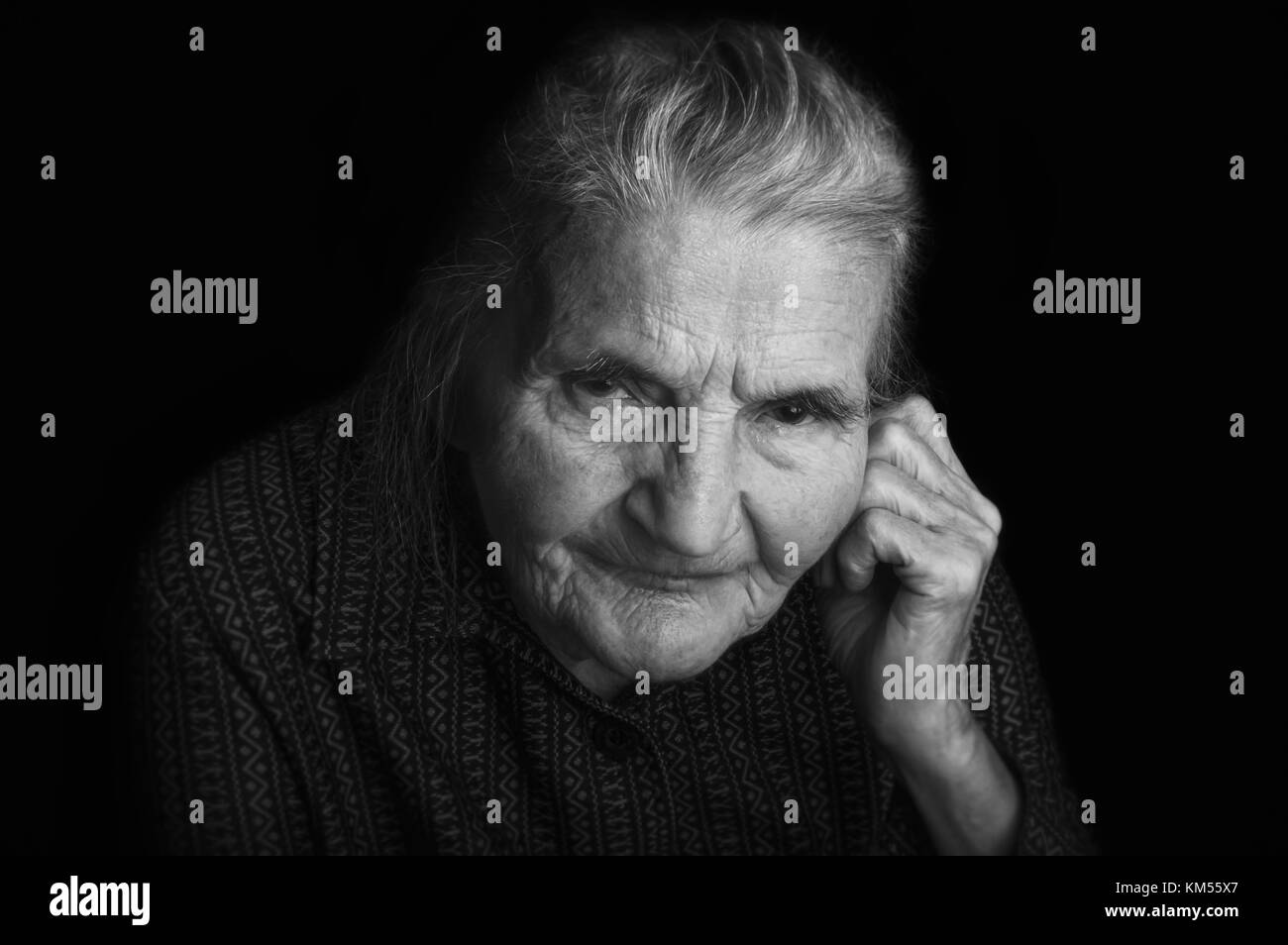 Portrait of a sad elderly woman. Dreaming the past. Selective focus. Stock Photo