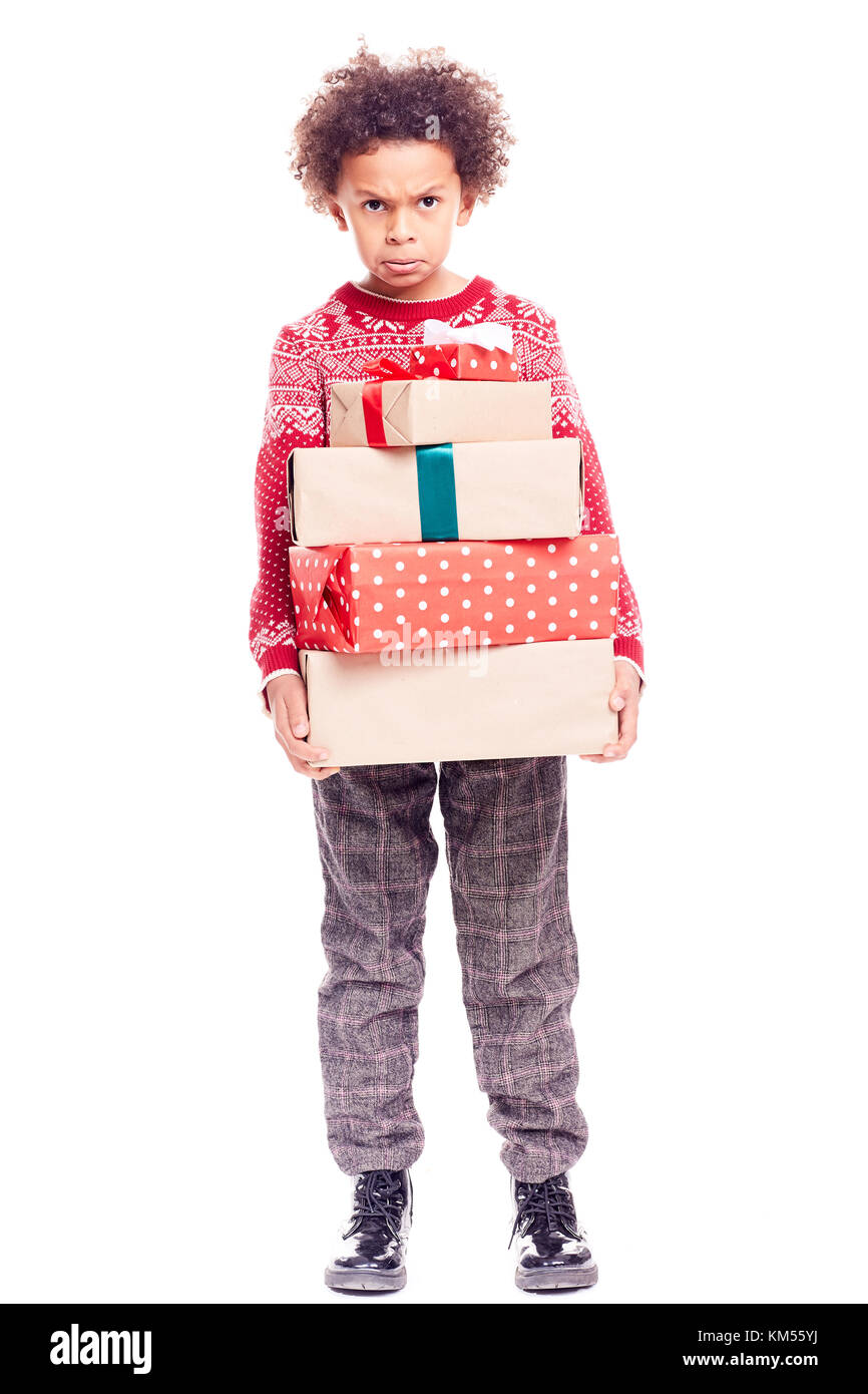 Boy with heap of Christmas gifts Stock Photo