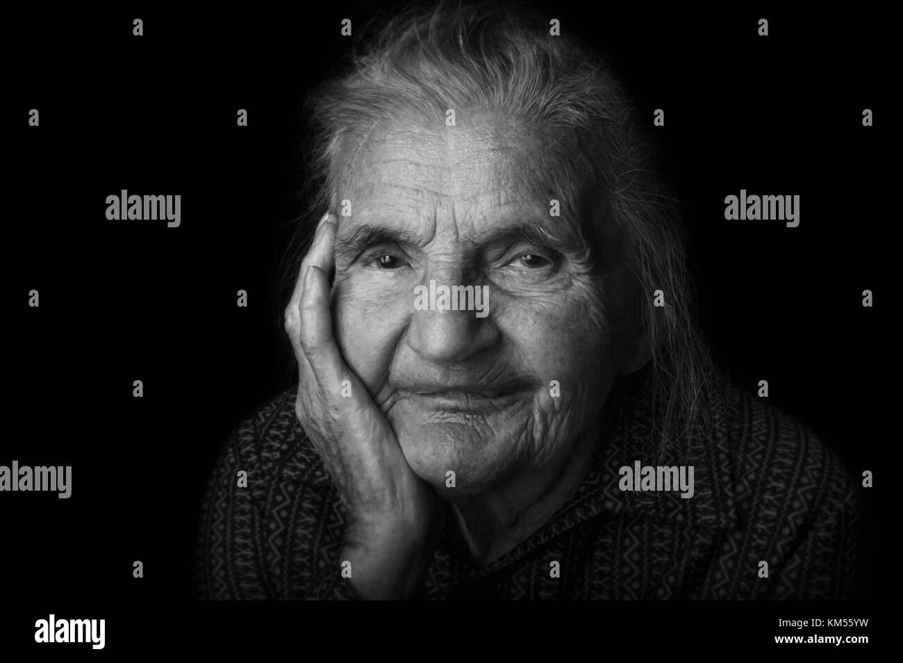 Portrait of a sad, nostalgic elderly woman. Evoking the past and worrying about the future. Selective focus. Stock Photo