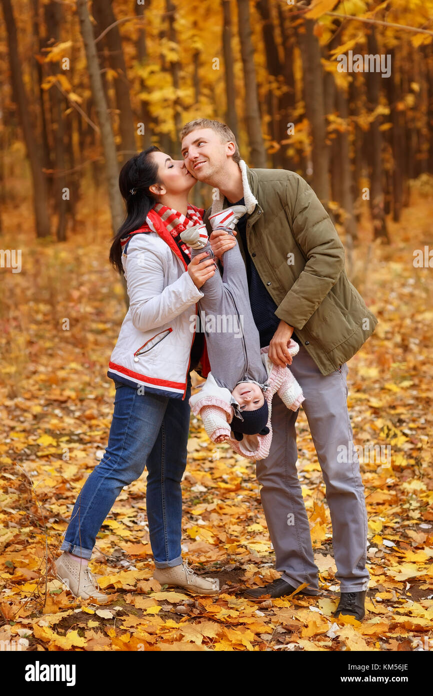 parents walk and play with little daughter Stock Photo