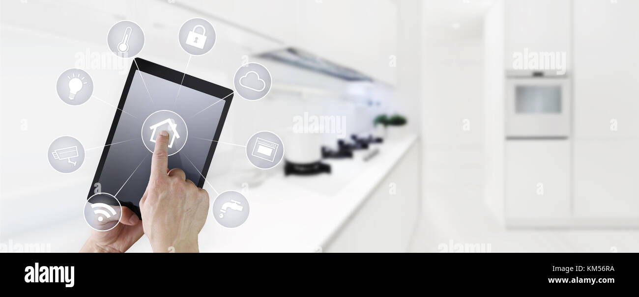 smart home automation hand touch digital tablet screen with symbols on kitchen background web banner and copy space template Stock Photo
