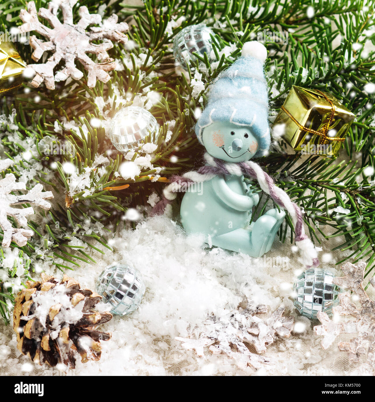 Blue snowman and christmas tree on snow background. Square image with ...