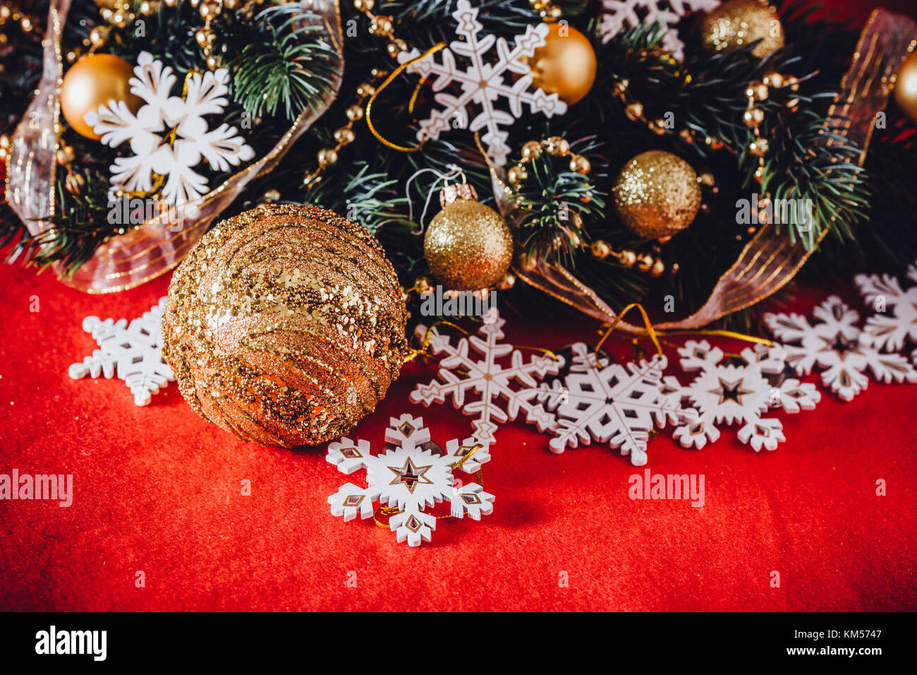 Christmas card with fir tree branch decorated with golden baubles ...