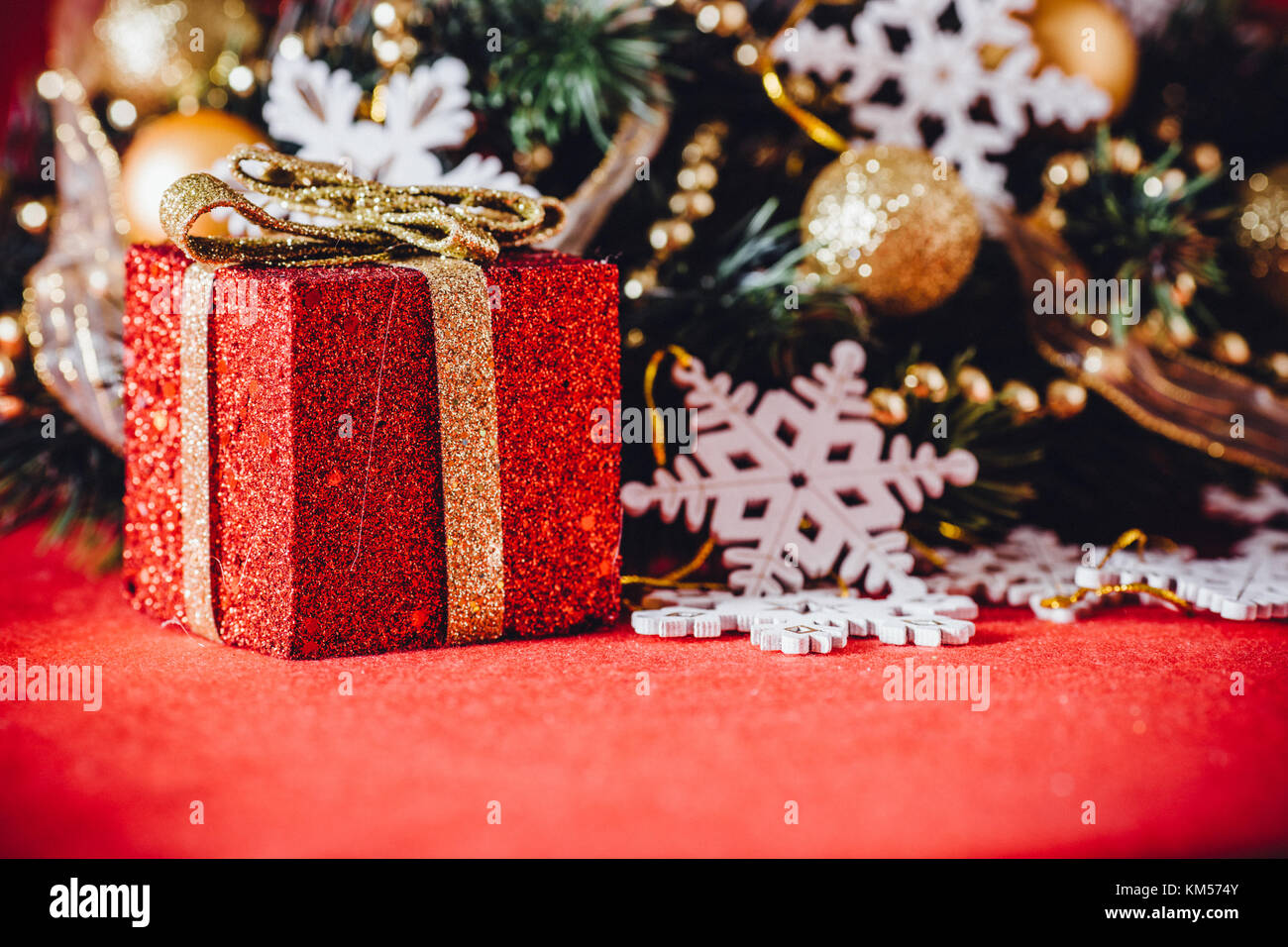 Christmas card with fir tree branch decorated with golden baubles ...