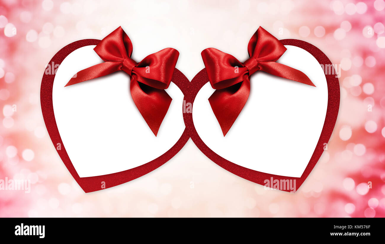 valentine heart shape gift card with red ribbon bow Isolated on blurred ...