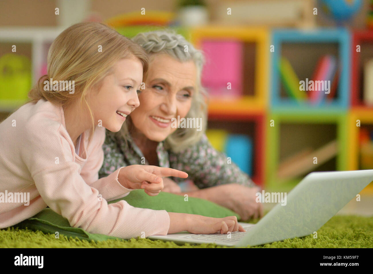 girl with grandmother using laptop Stock Photo - Alamy