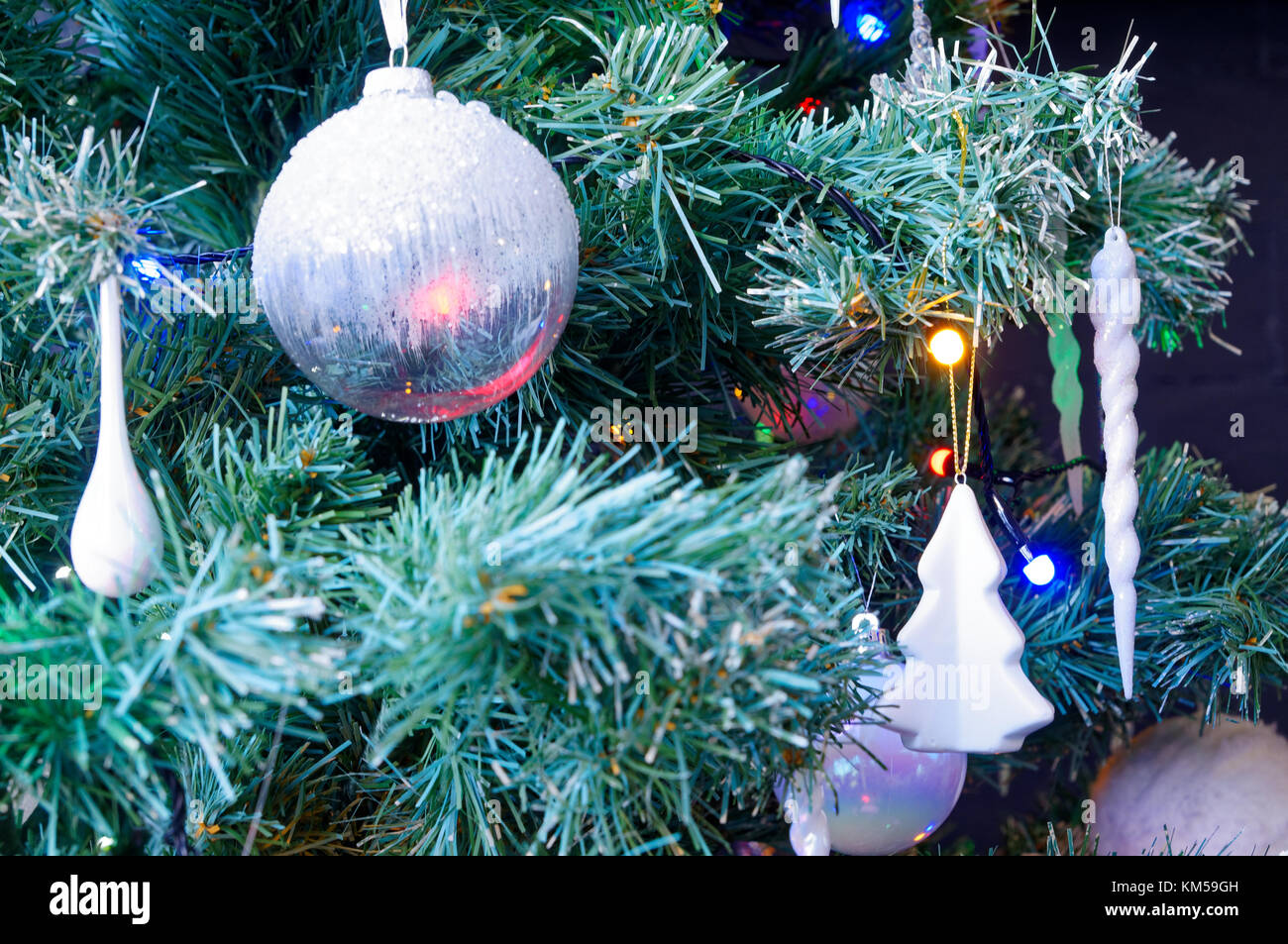 Closeup of white bauble and decoration on an xmas tree Stock Photo
