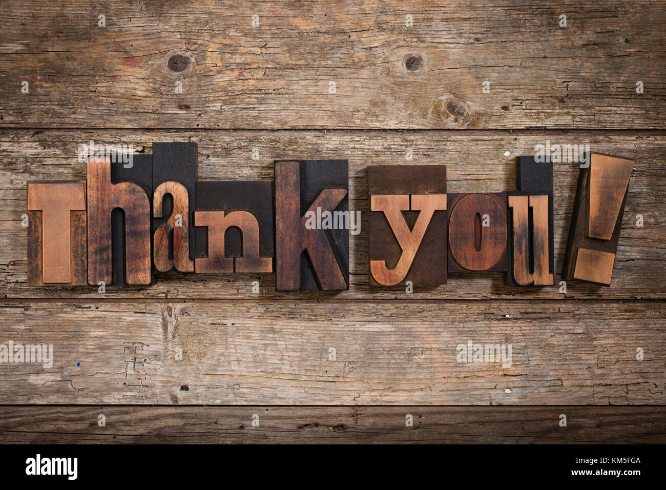thank you, phrase set with vintage letterpress printing blocks on rustic wooden background Stock Photo