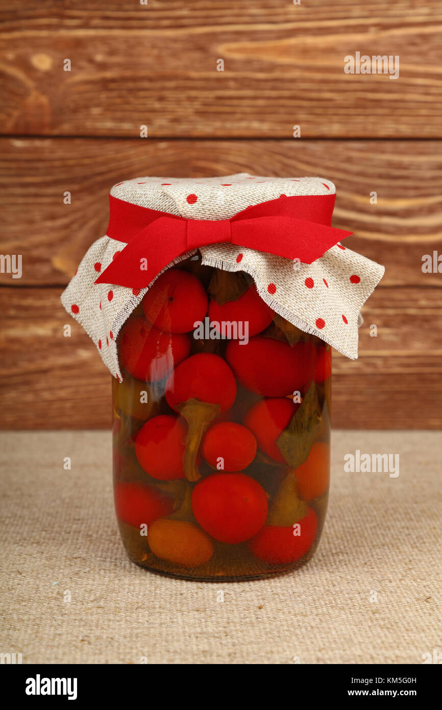 Close Up Of One Glass Jar Of Pickled Small Round Red Hot Cherry