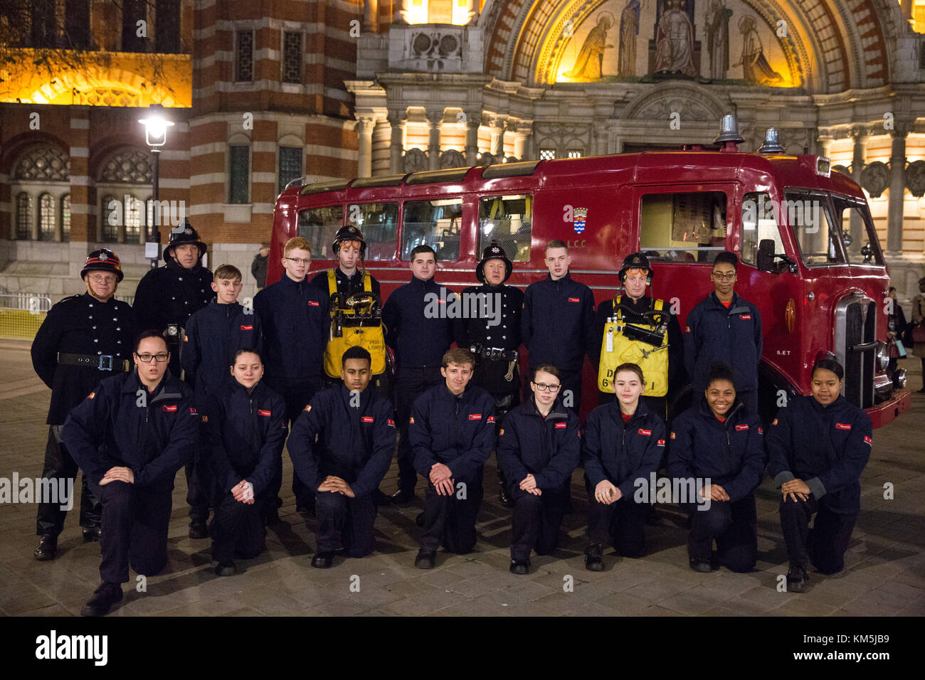 London, UK. 4th Dec, 2017. London Fire Brigade cadets and staff wearing period uniform stand in front of the 1954 Merryweather Emergency Tender vintage fire engine outside Westminster Cathedral prior to the arrival of Prince Harry to attend the London Fire Brigade carol service. The annual service features festive readings and traditional Christmas carols for London Fire Brigade's uniformed and non-uniformed members of staff and their families as well as retired ex-colleagues. Credit: Mark Kerrison/Alamy Live News Stock Photo