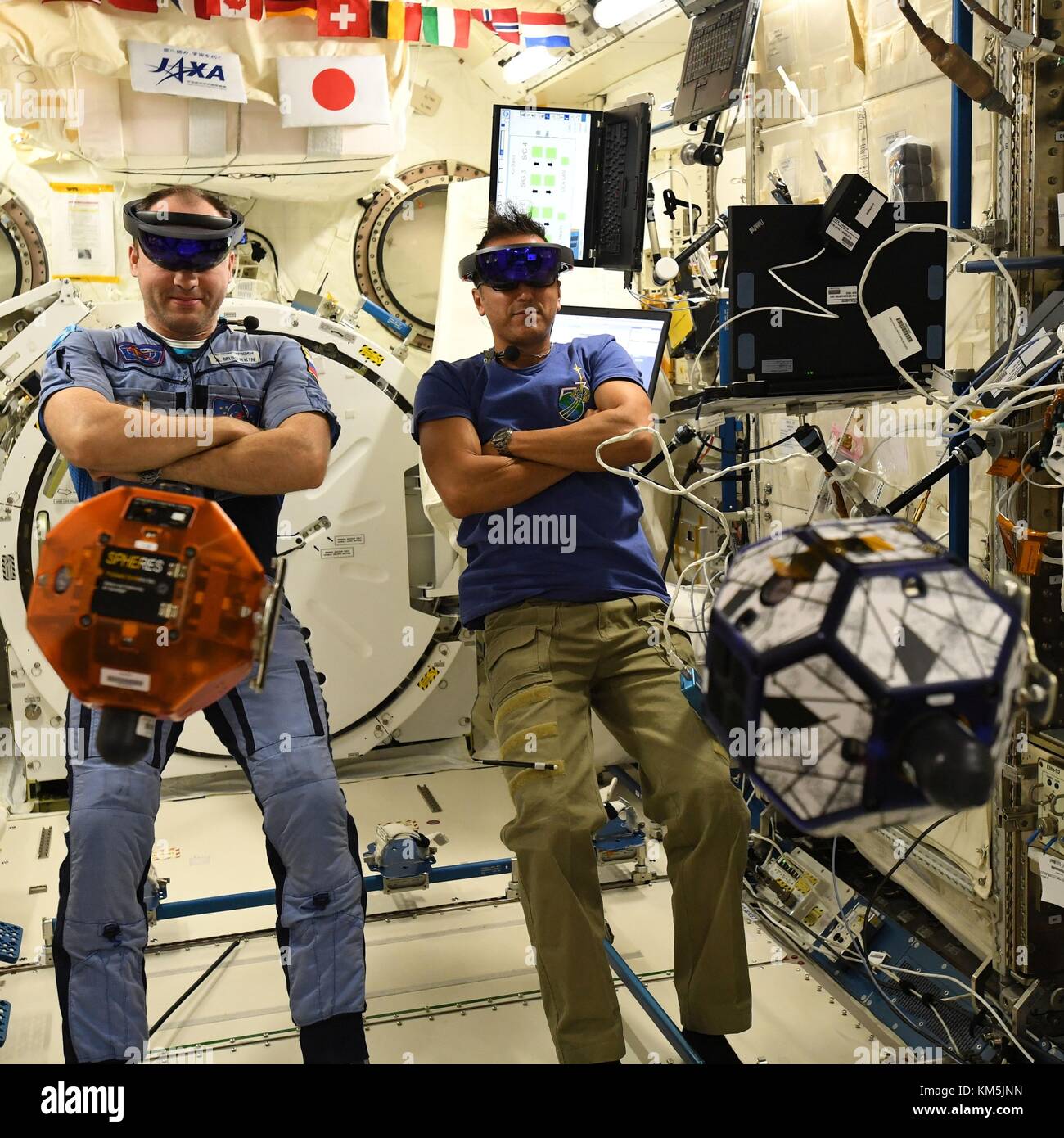 International Space Station, Earth Orbit. 04th Dec, 2017. Expedition 53 Russian cosmonaut Sasha Misurkin, left, and American astronaut Joe Acaba, right, look through VR goggles during a test of the Zero Robotics student project aboard the International Space Station December 4, 2017 in Earth Orbit. Zero Robotics is a robotics programming competition for High School and Middle School students using SPHERES satellites inside the International Space Station. Credit: Planetpix/Alamy Live News Stock Photo