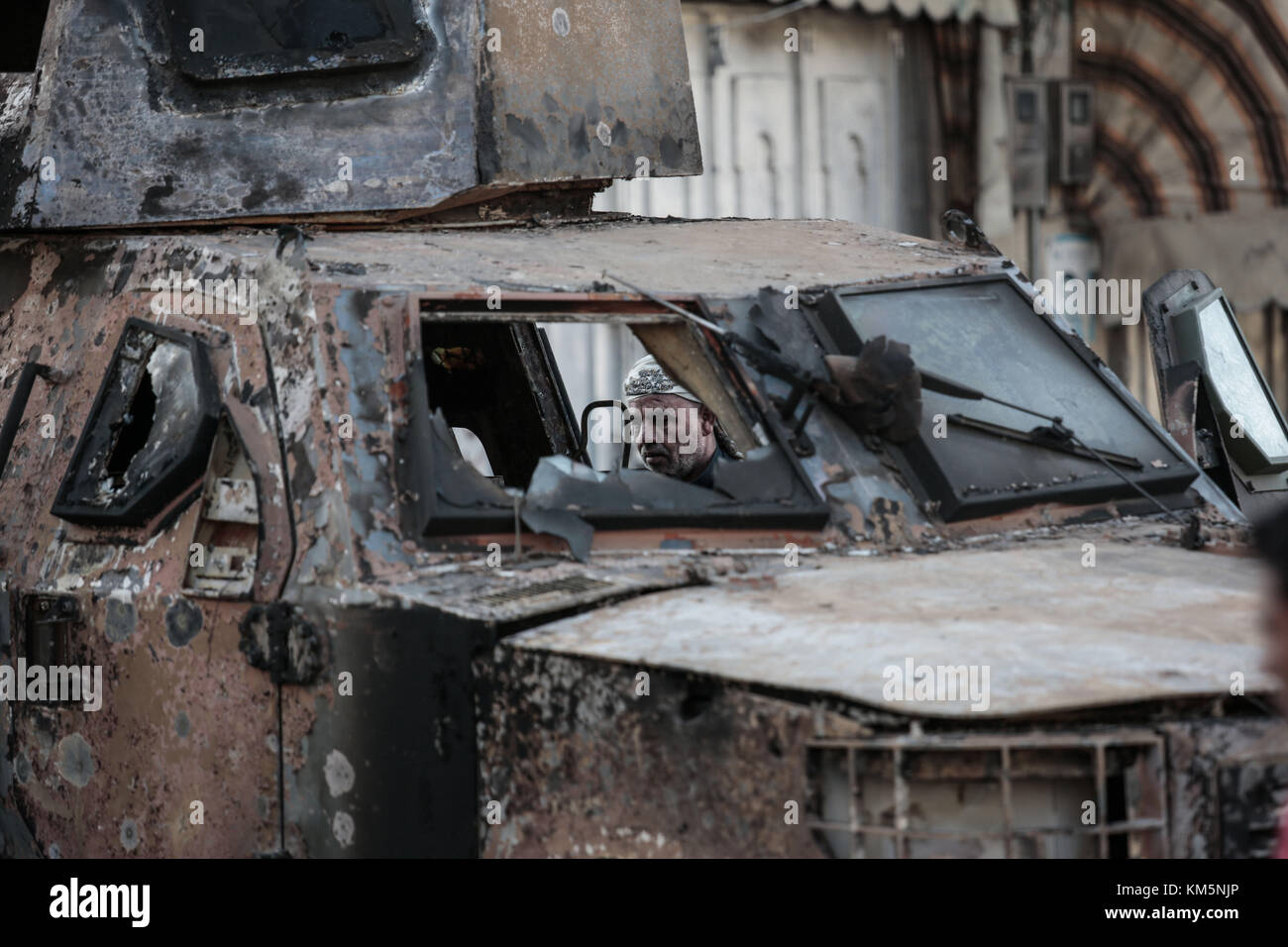 Sanaa, Yemen. 05th Dec, 2017. Yemeni man inspects a military vehicle destroyed in clashes between Houthi fighters and forces loyal to Yemen's former President Ali Abdullah Saleh in Sanaa, Yemen, 05 December 2017. Saleh was killed by Houthi rebels on Monday. Credit: Hani Al-Ansi/dpa/Alamy Live News Stock Photo